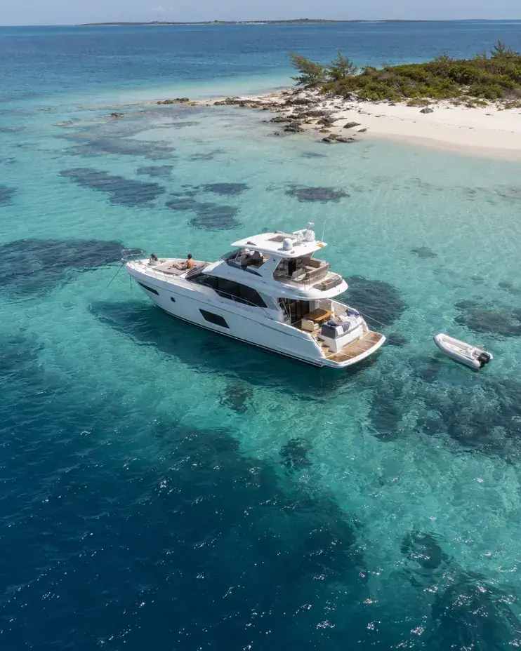 Multi-day yacht charter from Miami to the Bahamas, yacht anchored over a sandbank