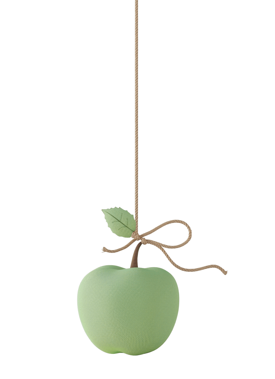 Мягкая игрушка в виде зеленого яблока, подвешенная на веревочке