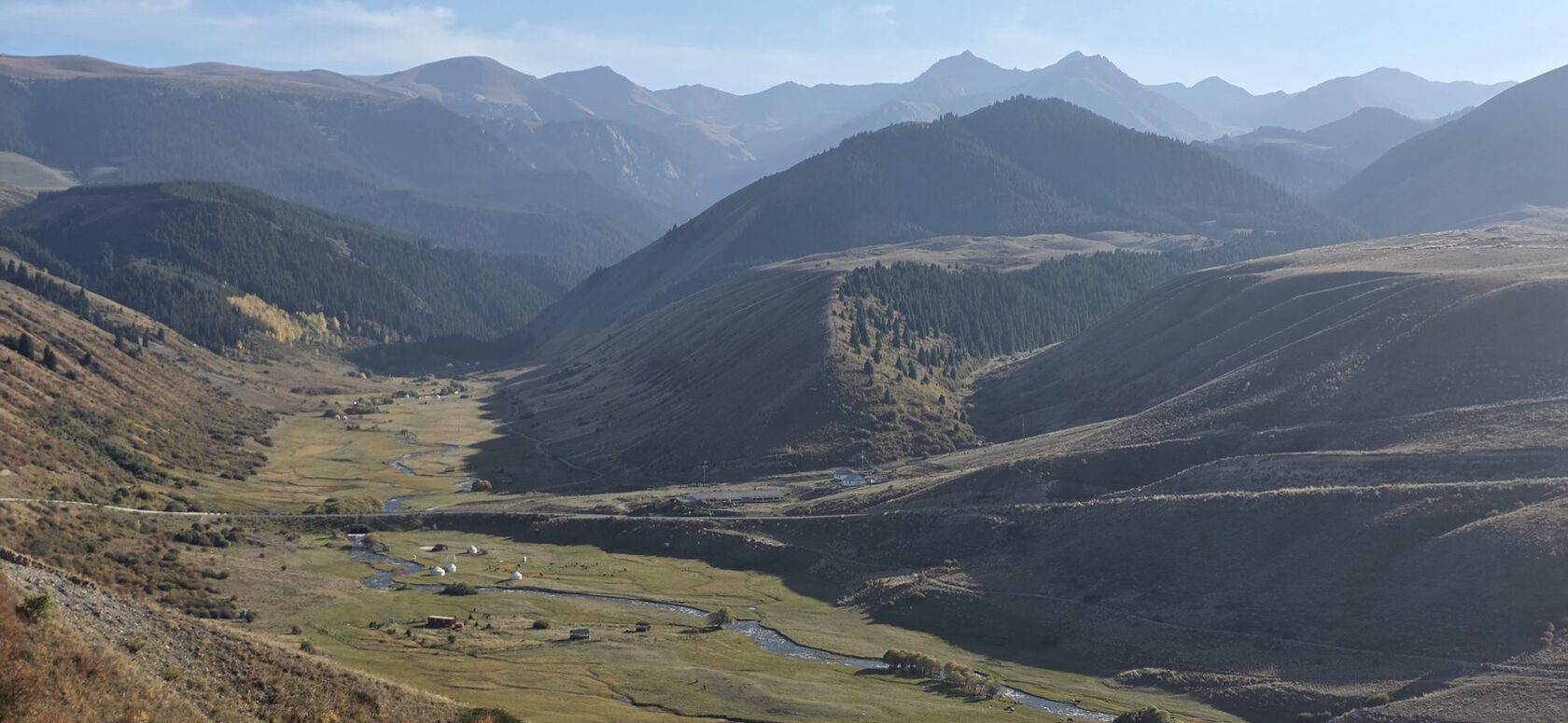River valley with yurts on the road to the Kolsai Lakes, Kazakhstan