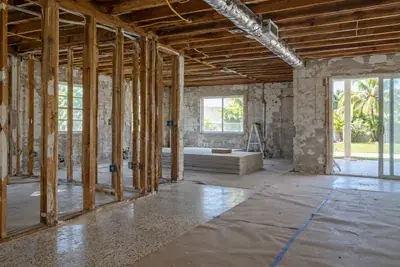 House interior opened to the block walls and joists during a renovation