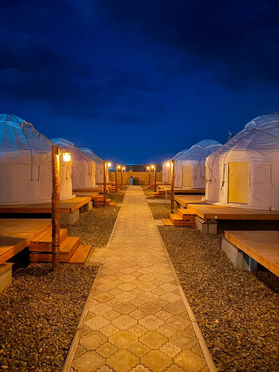 Evening lights around yurts at Qazaq Camp