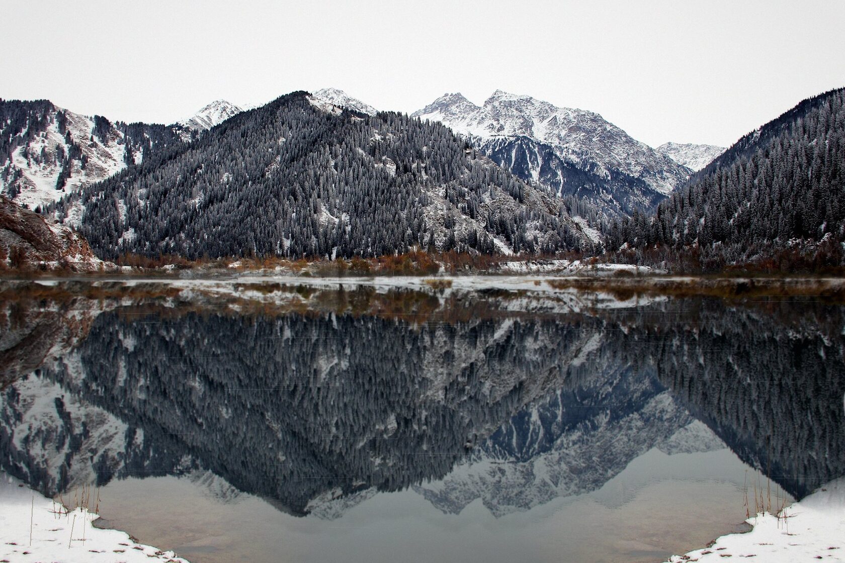 Winter Issyk Lake with mountain reflections in the water