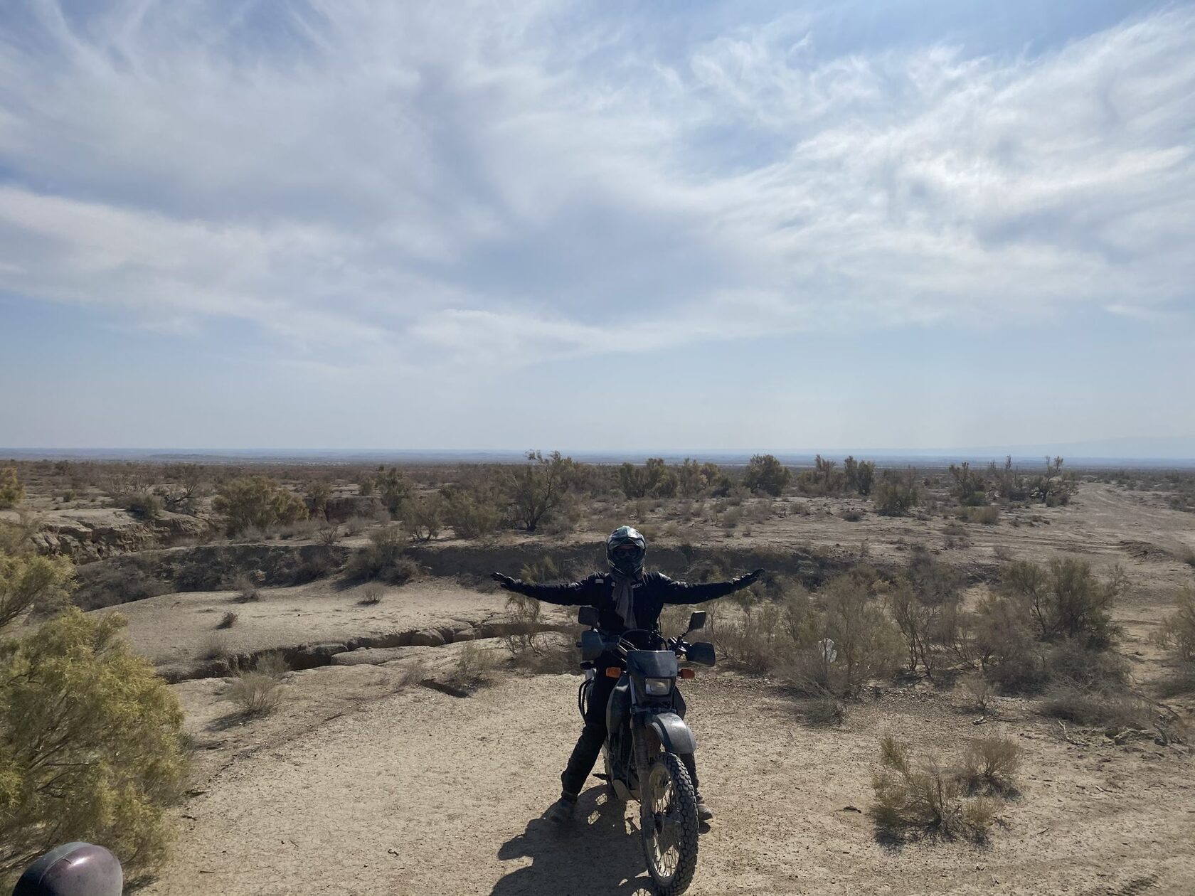 Rider on a motorcycle on a dirt road in Altyn-Emel National Park